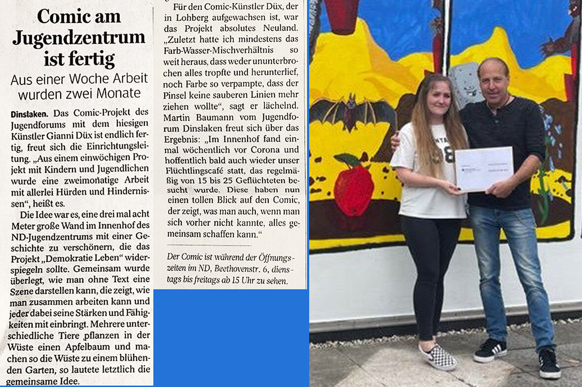 Pressefoto des Künstlers Gianni Düx und einer Mitarbeiterin des Jugendzentrums vor der Wand mit der fertigen Comiczeichnung.